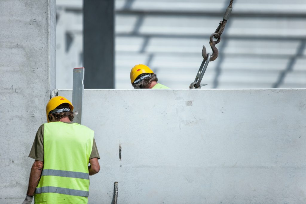 Selective focus shot of workers in the construction of a residential complex
